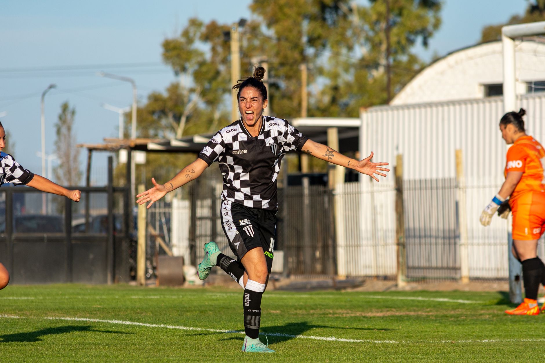 female soccer player celebrating goal outdoors